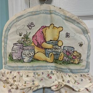 Classic Winnie the Pooh diaper stacker, light switch cover, and music box